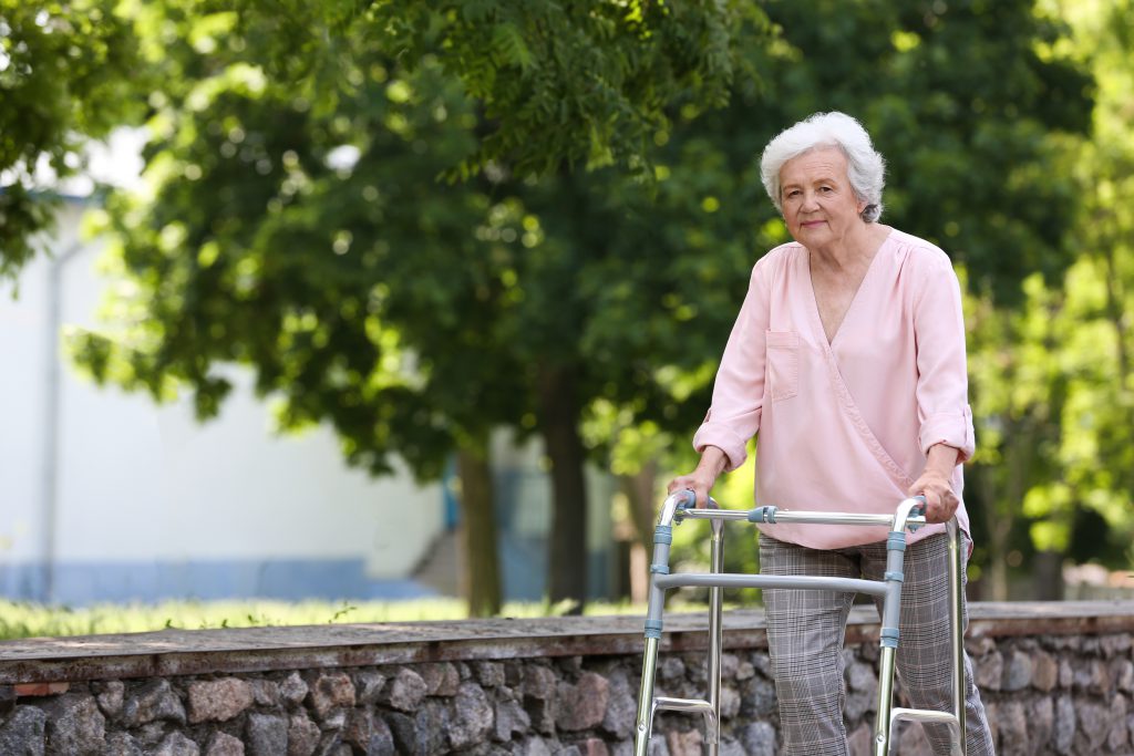older person walking with frame